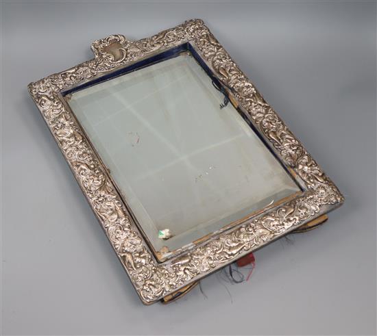 An Edwardian repousse silver mounted rectangular easel mirror, William Comyns, London, 1905, 43.7cm.